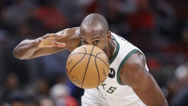 Milwaukee Bucks forward Khris Middleton (22) goes after the ball 